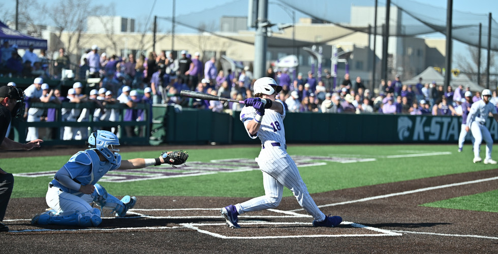 A K-State baseball player hits the ball.