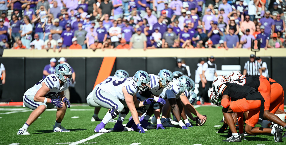 The K-State and OSU linemen crouch down preparing to hike the ball.