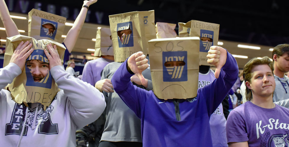 K-State fans put a thumbs down gesture with brown bags on their heads. Courtesy: Paige Mueller