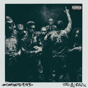 The album cover for "It's Us Vol. 2" features a group of individuals standing together in a powerful formation, dressed in camouflage-patterned clothing, with an urban and edgy vibe.