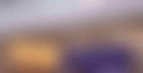 A crowd watches Casey Alexander talk underneath a large powercat logo.