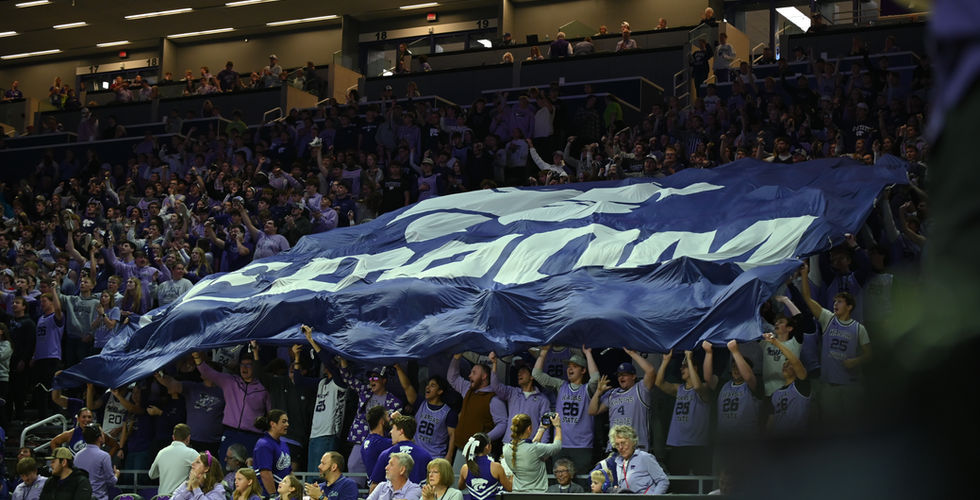 The DOOM sheet is held up by students over the student section.