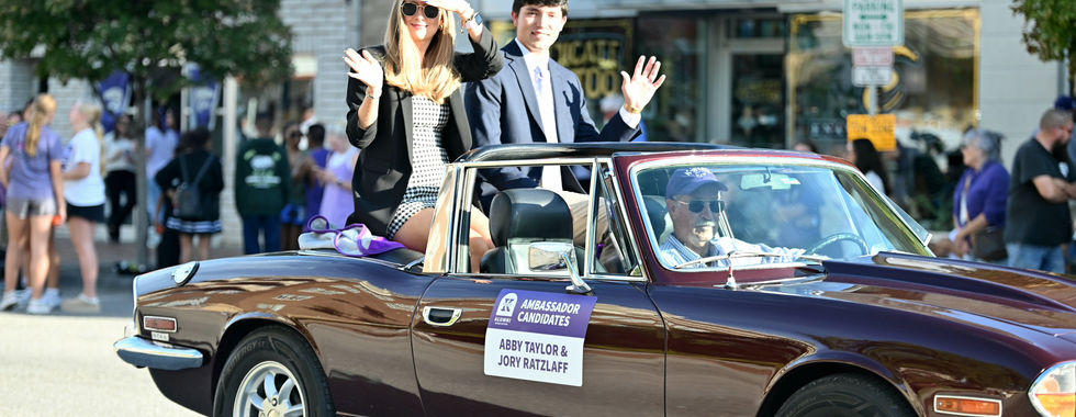 Student ambassador candidates Abby Taylor and Jory Ratzlaff in a black vehicle.