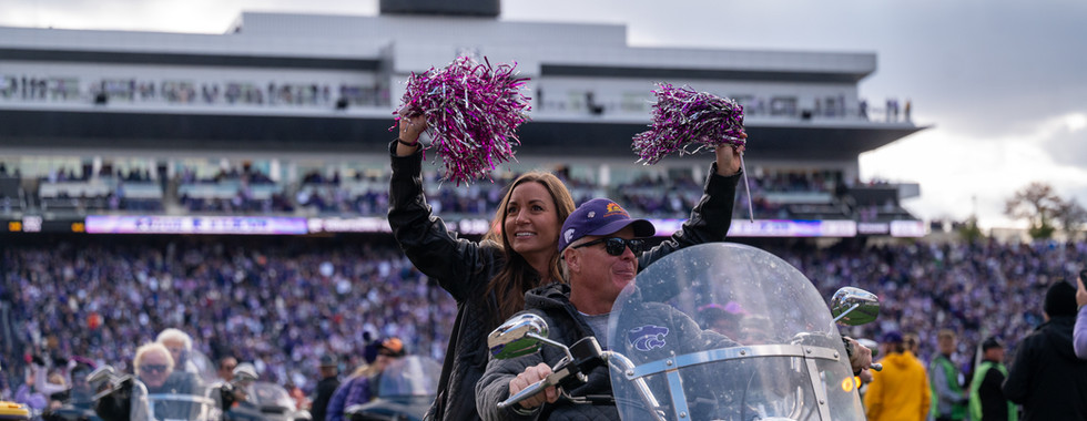 A woman holds up pompoms on a harley. Courtesy: Ashton Todd