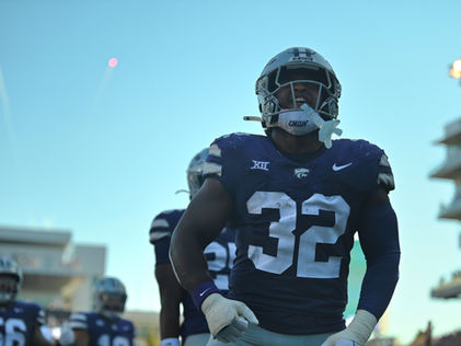 Desmond Purnell celebrates after intercepting the ball and scoring a touchdown.