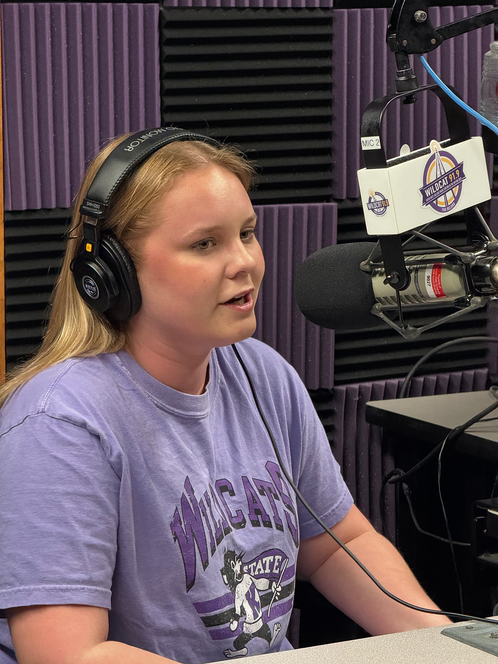 Zoey Pudenz talking behind a Wildcat 91.9 microphone.