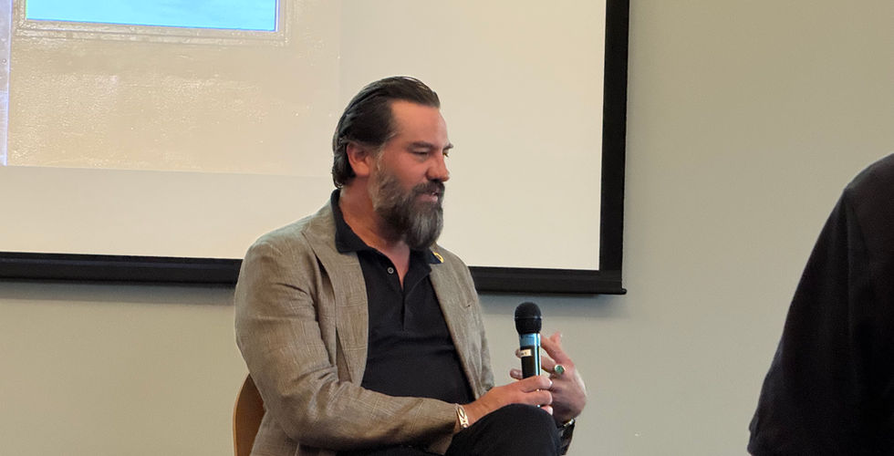 Jeremiah Ariaz sits and talks during his presentation