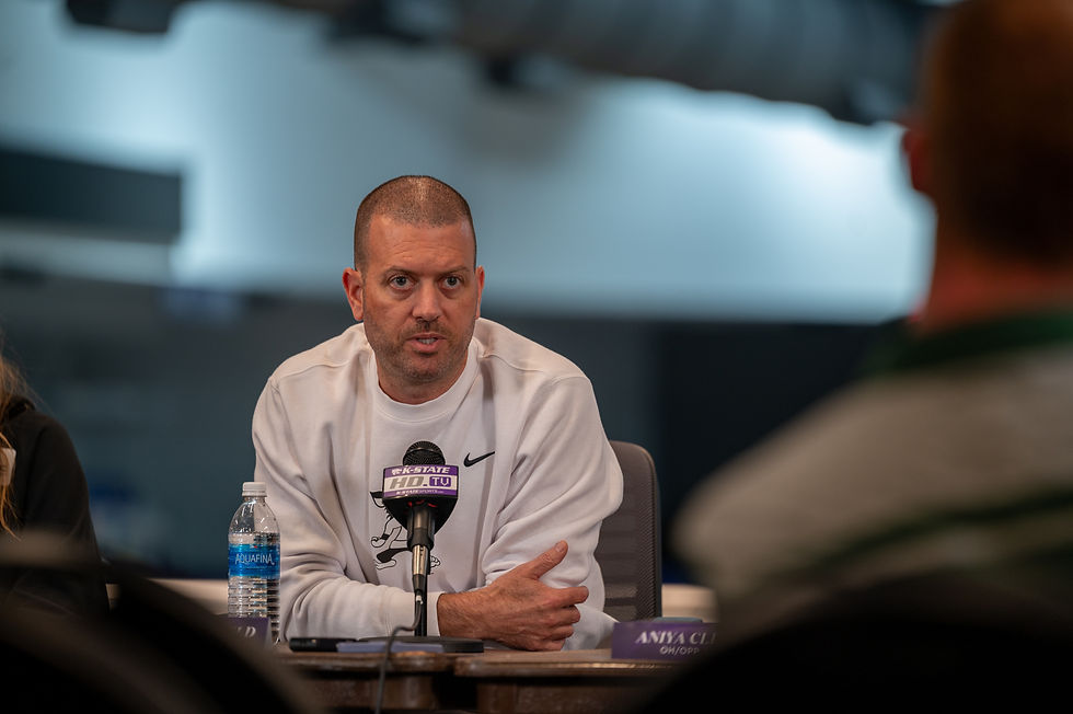 Jason Mansfield sits behind a microphone at press conference.