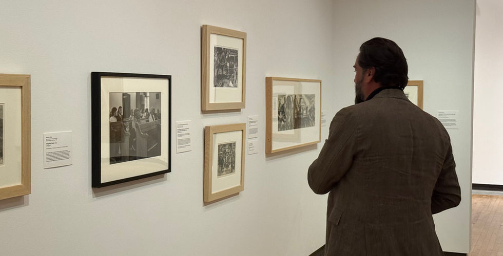 Jeremiah Ariaz observing his gallery of photos in the Beach Museum of Art