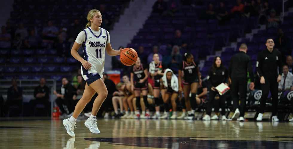 Taryn Sides dribbles the ball down the court.