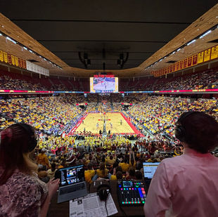 Ely Burroughs and Ella Arnes lookout over Hilton Coliseum in Ames, Iowa.