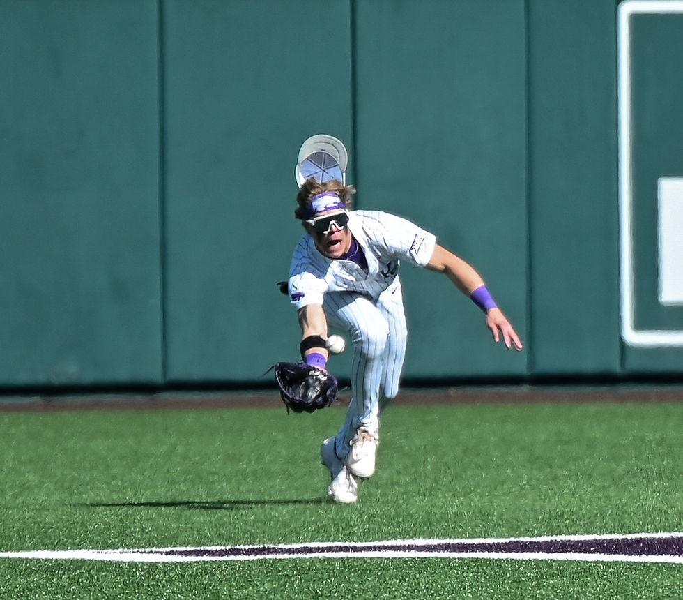 A K-State baseball player lunges for the ball.