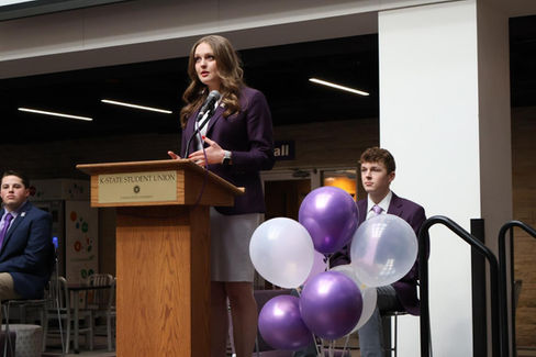 Lauren Wolter speaks in front of a lectern on stage.