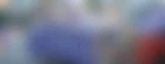 A float in the parade with a pomped K-State on the side in purple and white.