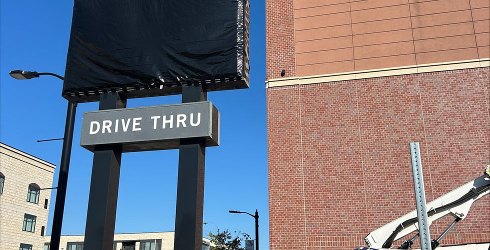 The starbucks sign in front of the Aggieville location has a black tarp over it.