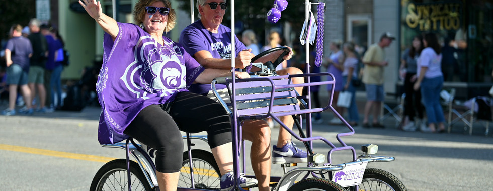 A couple waves in k-state gear while riding a 4-wheeled bike. Courtesy: Zoe Taylor