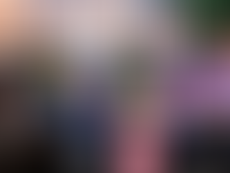 Peter and Jacob sit on chairs with a box and pink bucket between them.