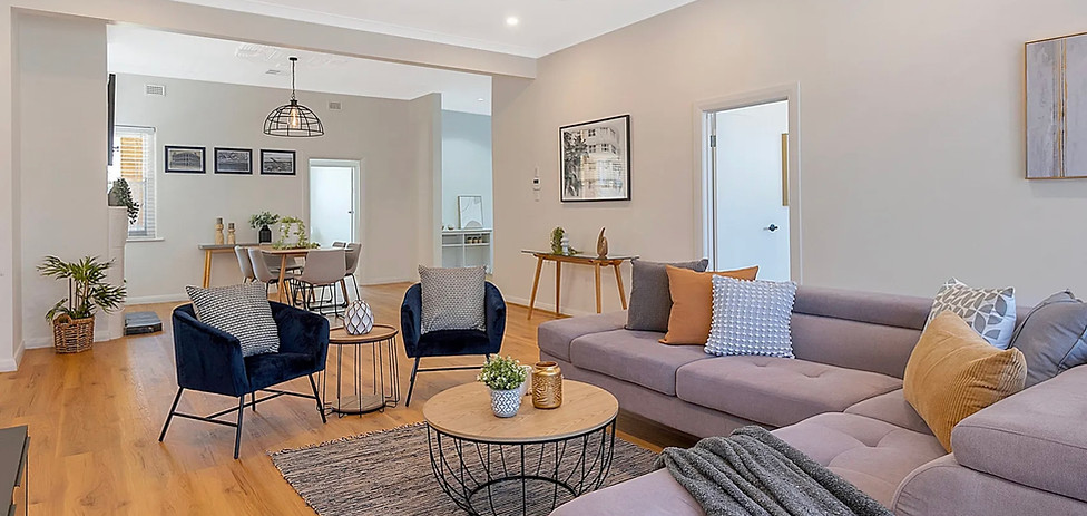 Spotless, modern living room with comfortable furnishings and contemporary design, impeccably cleaned by Tidy Delights.