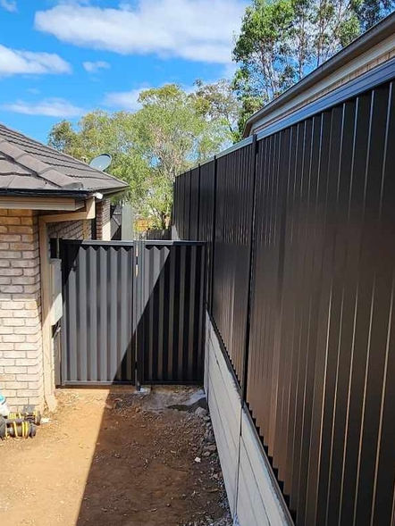 Colorbond fence showcasing contemporary & durable design in various landscape settings. Colour in monument