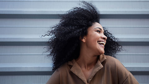 young-black-woman-with-afro-hair-laughing-enjoying.jpg