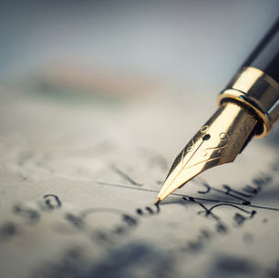 fountain pen writing cursive on a page