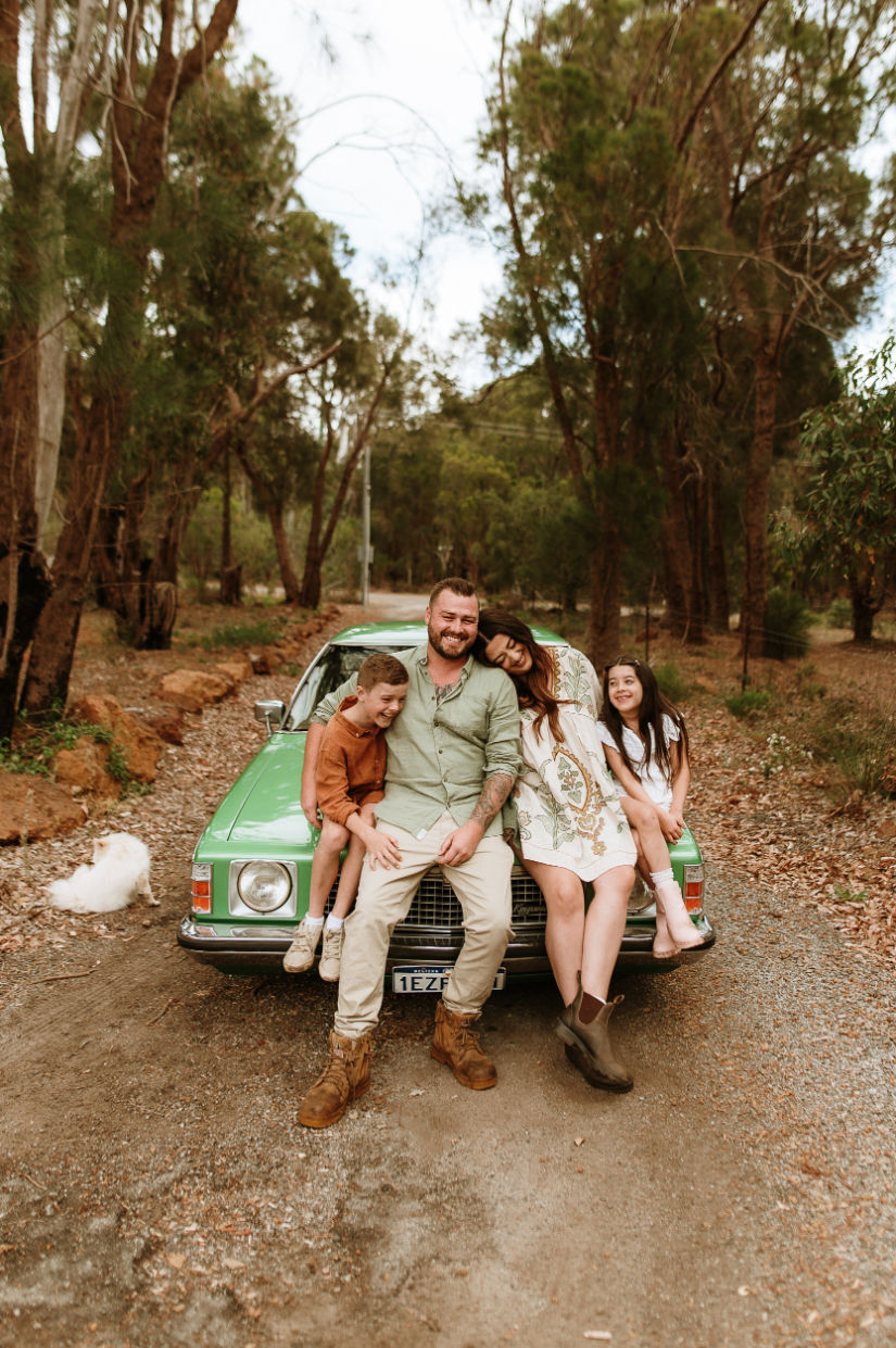 Family Photography Perth family of four leaning on the bonnet of a retro car 