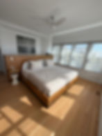 Bedroom cleaning - freshly made bed and dusted surfaces