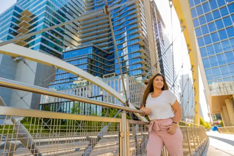 Woman on a glass walkway in downtown Austin