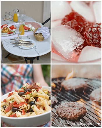 Outdoor balcony table set for breakfast with fresh fruit and bread, frozen raspberries in a chilled drink, pasta salad with olives and tomatoes, and burgers grilling over an open flame