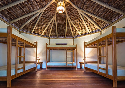 Interior of shared cabana accommodation with double beds wooden design and panoramic window