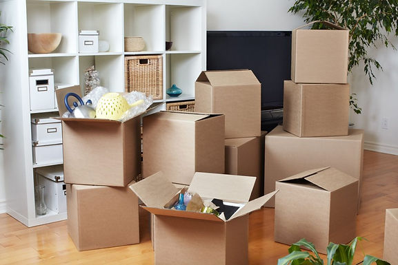 Expert Professional Organization Services: Packed moving boxes illustrating orderly Oasis, LLC services. We excel in decluttering, packing, labeling and organizing for a seamless transition, offering stress-free professional organization solutions.