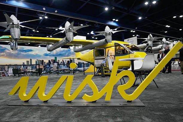 Wisk autonomous electric vertical takeoff and landing aircraft displayed behind the company’s logo at an aerospace exhibition.