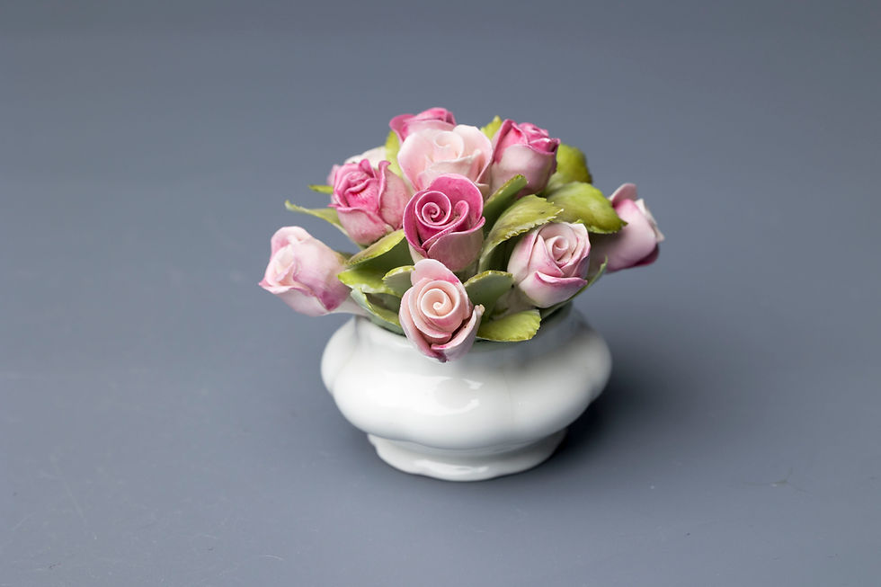 This is a Royal Albert bone china floral posy arrangement in the "Flower of the Month Series – Roses"