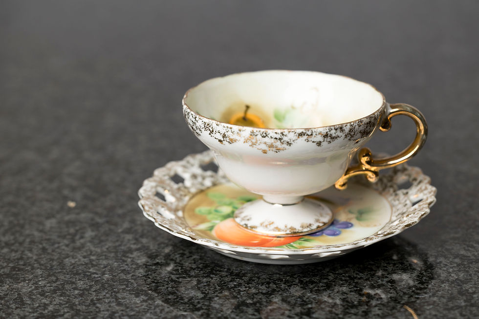 The pierced saucer and gold accents are features seen in Viennese, Czechoslovakian, Austrian or German porcelain rather than