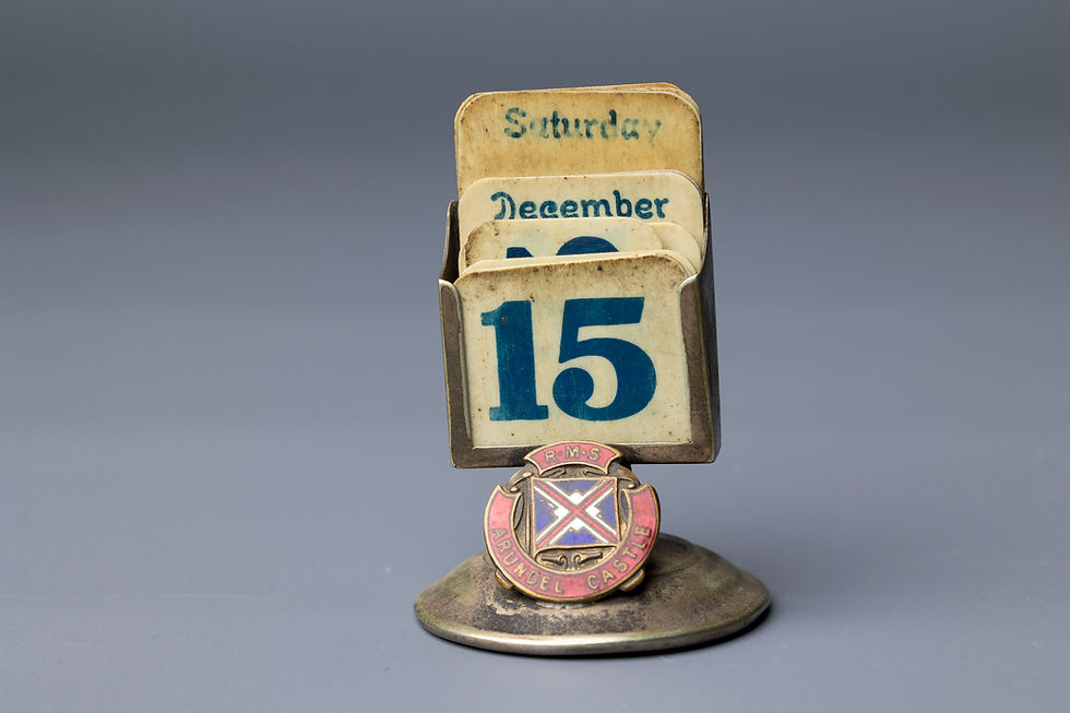 This charming desk accessory is a perpetual calendar featuring a removable set of date, month, and weekday cards displayed