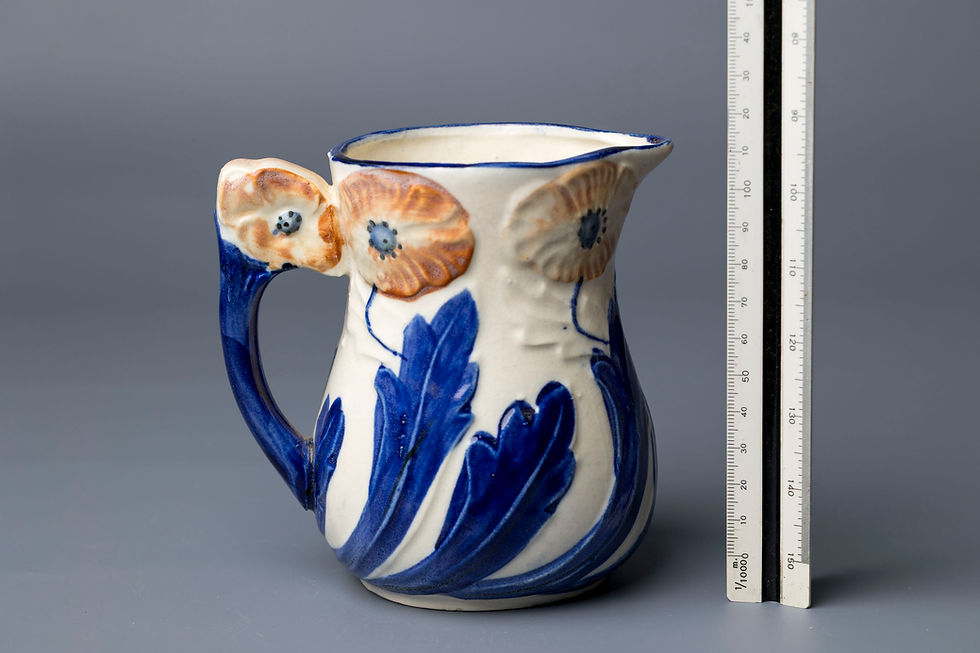 This hand-crafted ceramic jug features a vivid Art Deco or late Art Nouveau design, with applied relief poppy flowers