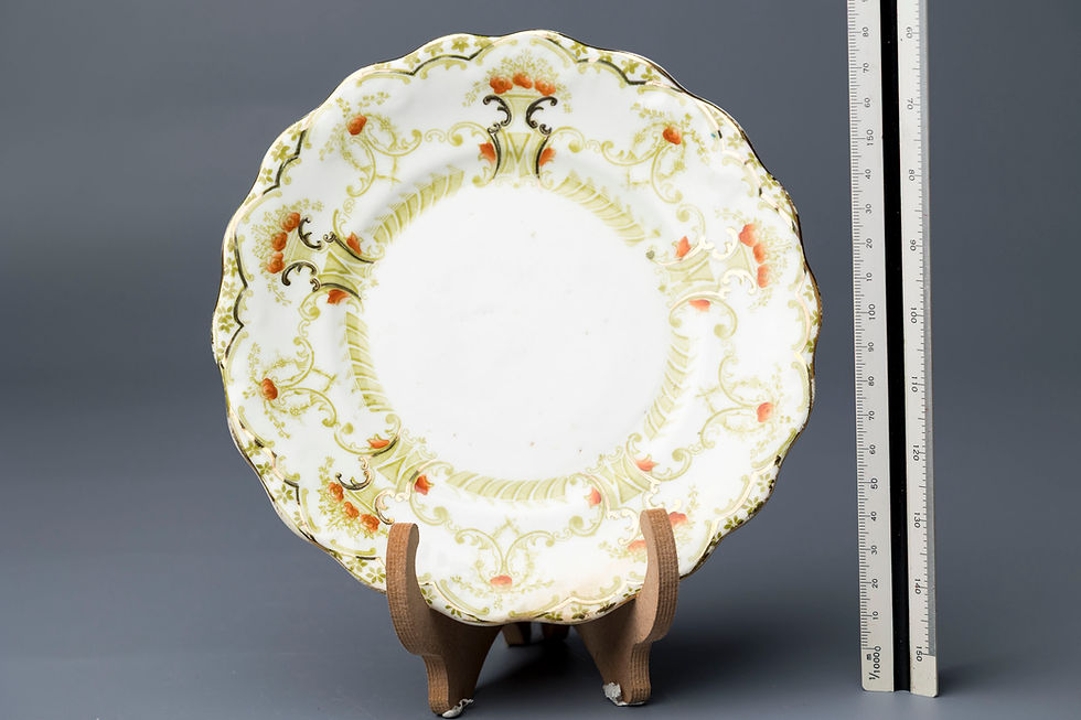 This is a decorative scalloped-edge porcelain plate produced by J.H.C. & Co