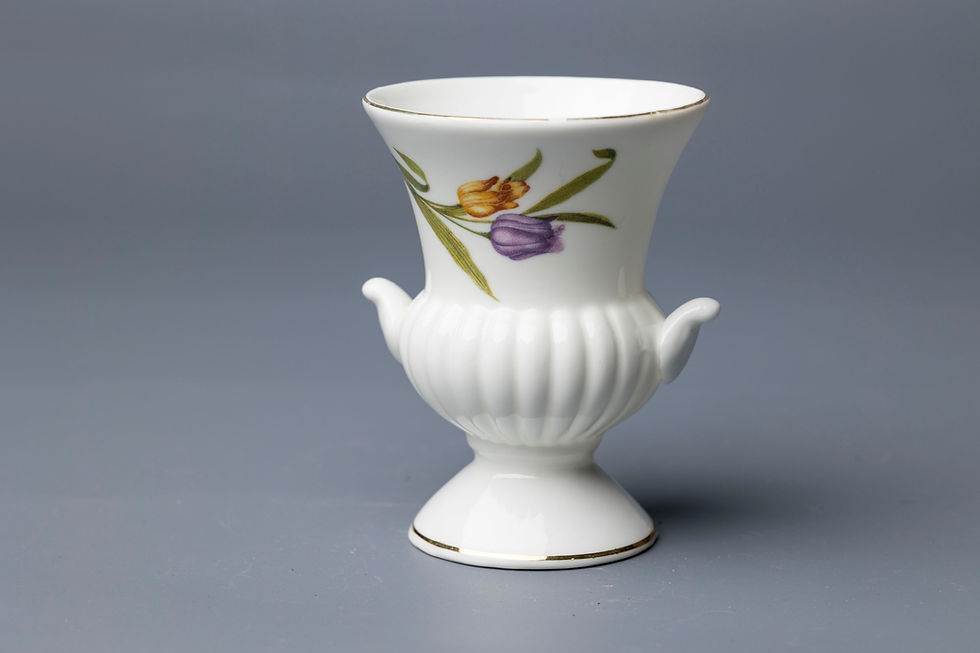 This dainty porcelain urn stands approximately 12–13 cm high and features a bulbous fluted body, flared rim,