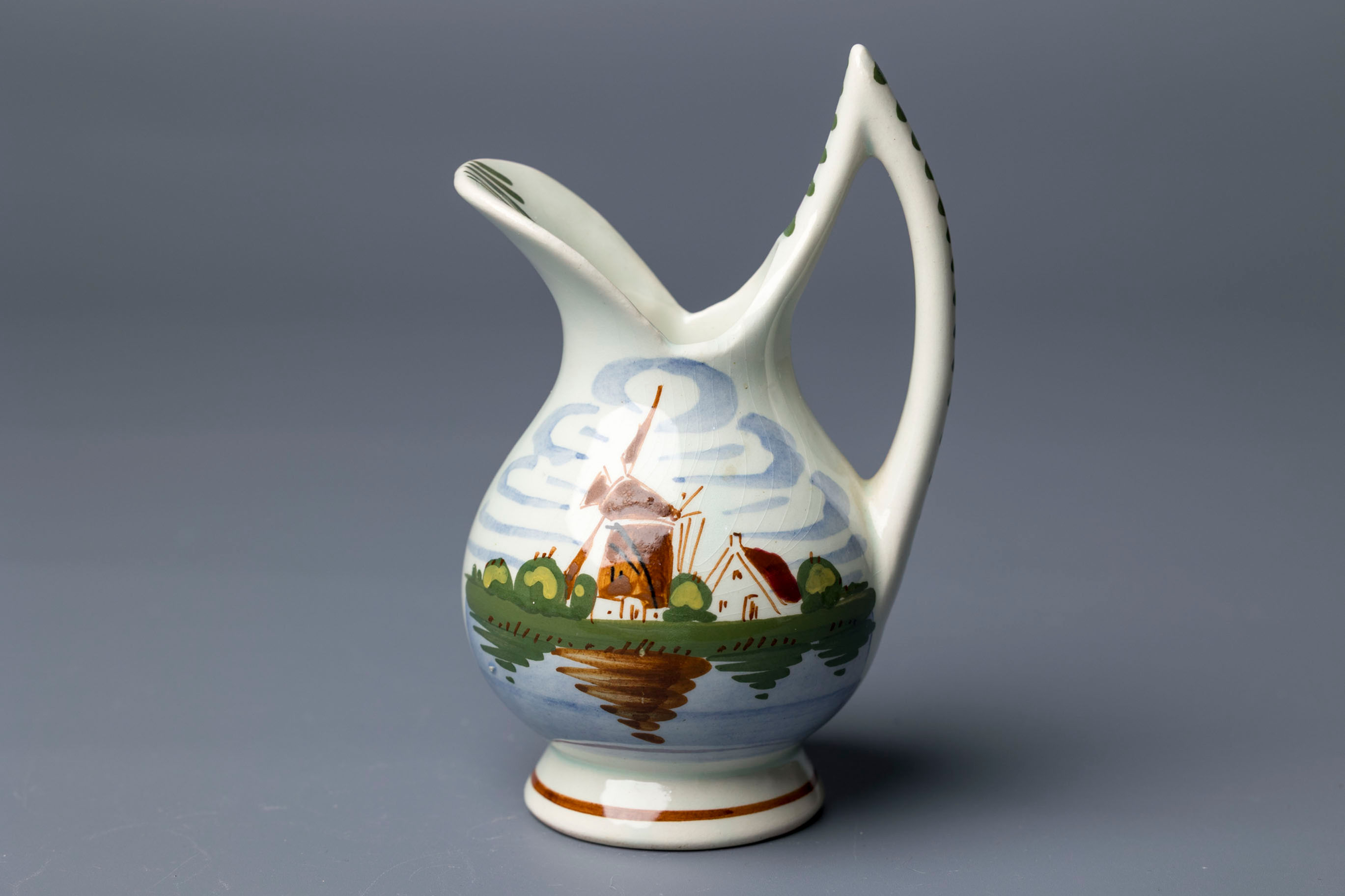 This striking pitcher or jug is a fine example of mid-century Delftware export pottery, made in Holland.