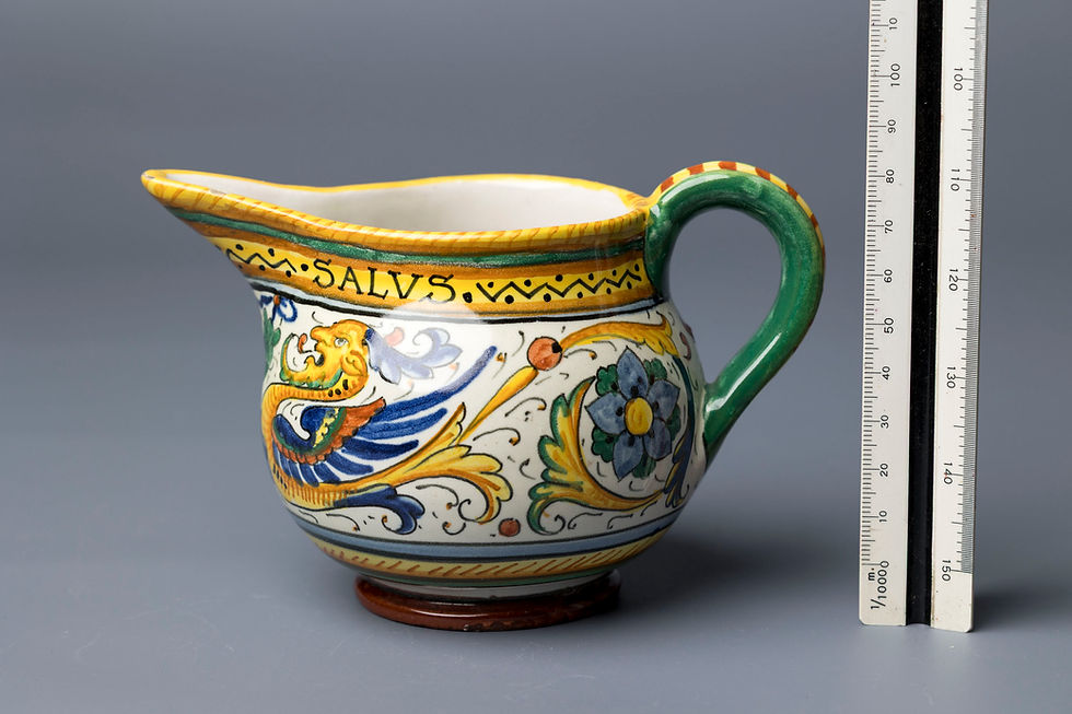 This highly stylized earthenware pitcher features a vibrant example of Deruta maiolica—a traditional tin-glazed ceramic ware