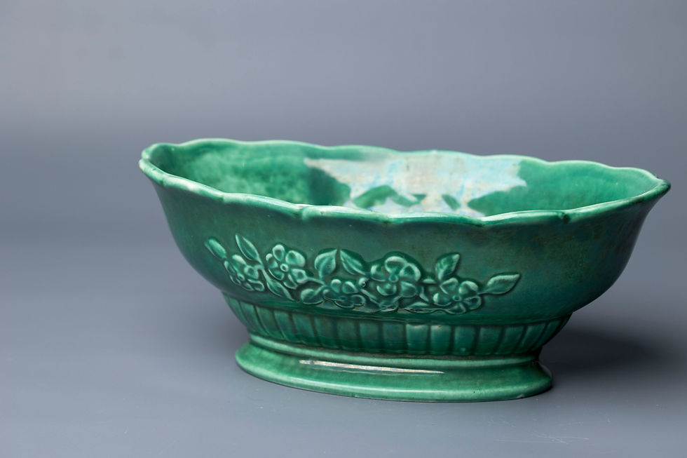 This is a mid-century green glazed ceramic bowl, likely American-made, marked “LUCIA 8402” on the base.