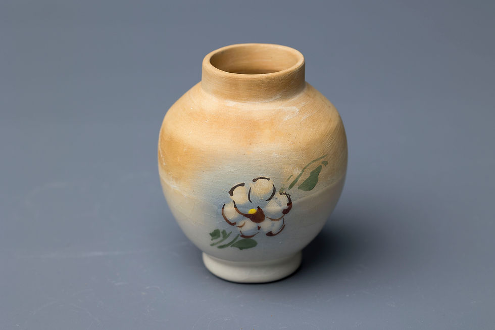 This miniature decorative vase displays characteristics typical of mid-20th century hand-decorated studio pottery.