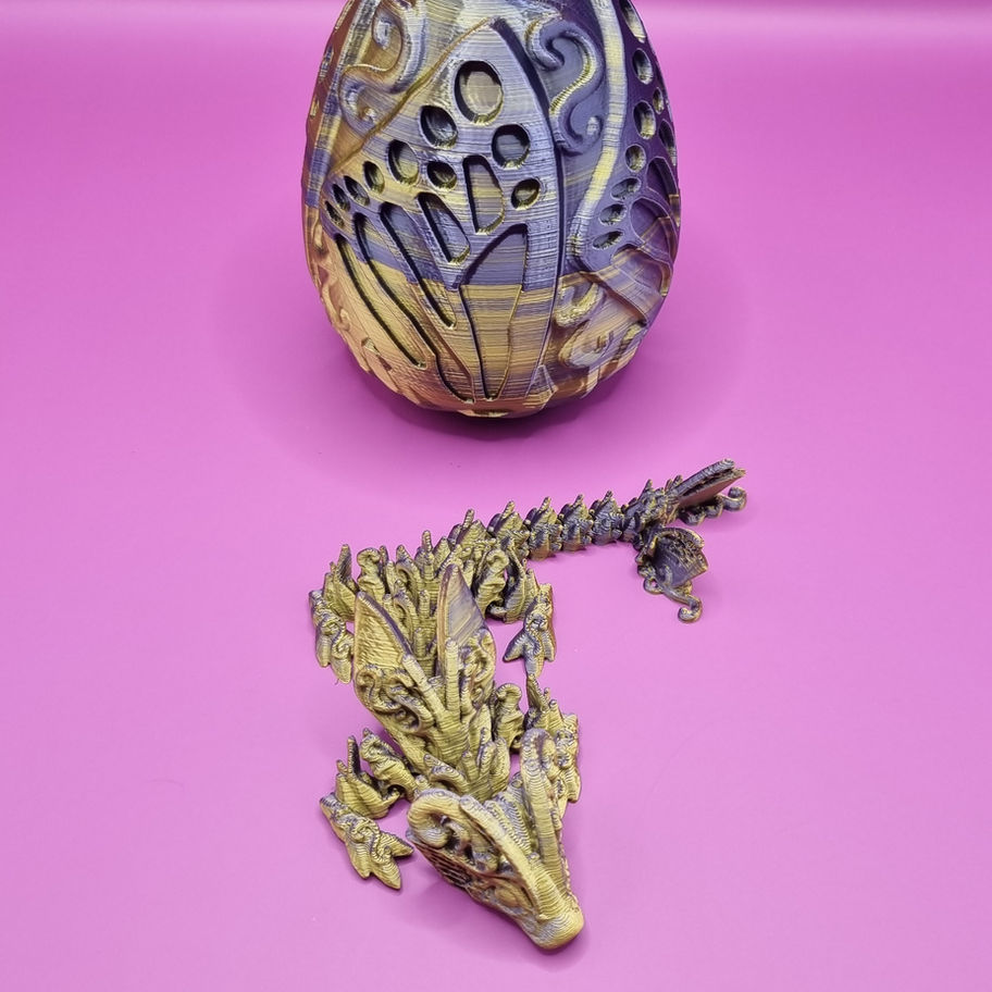 Golden and grey dragon egg with alligator figure