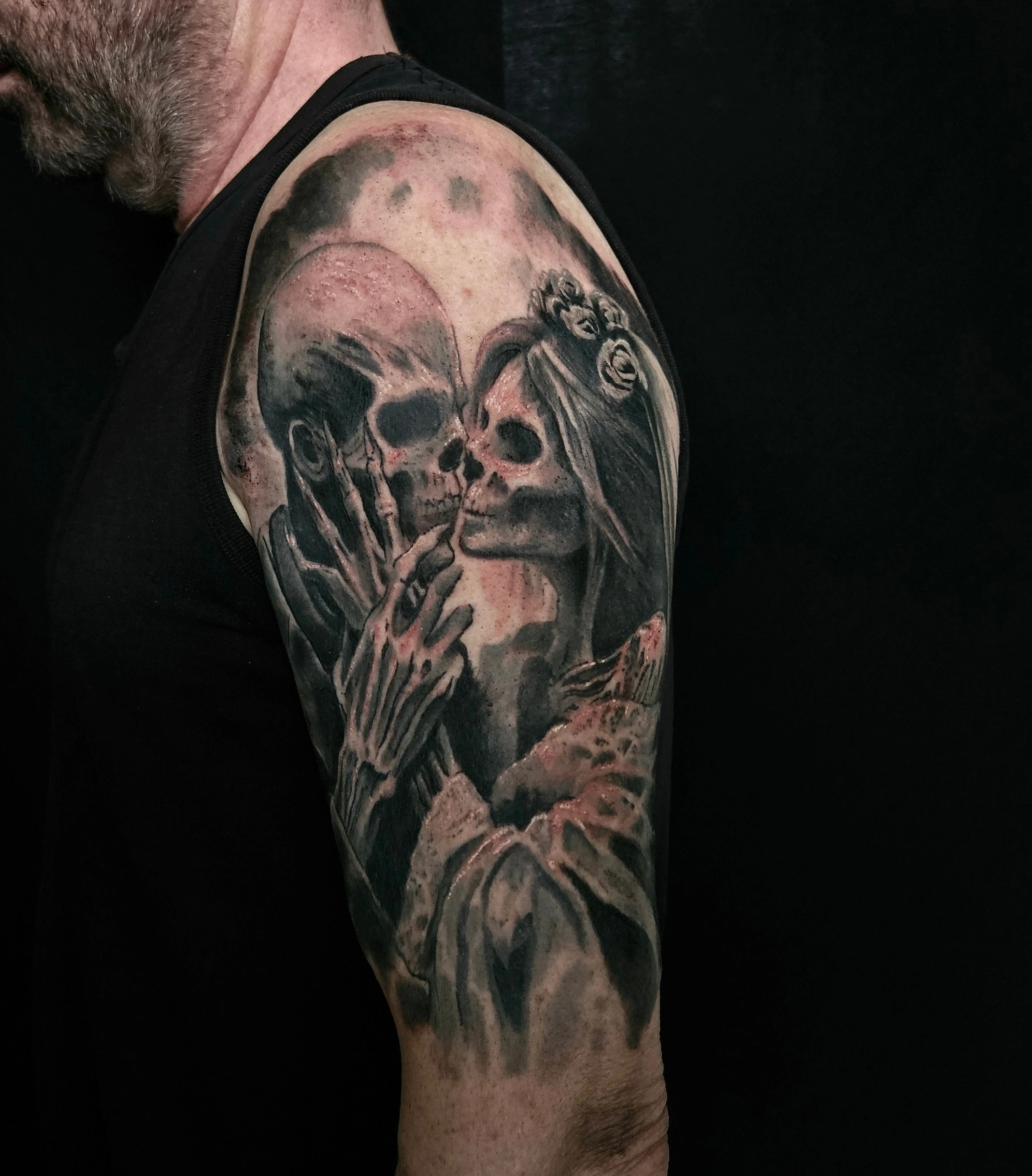 Black and grey woman embracing a skull
