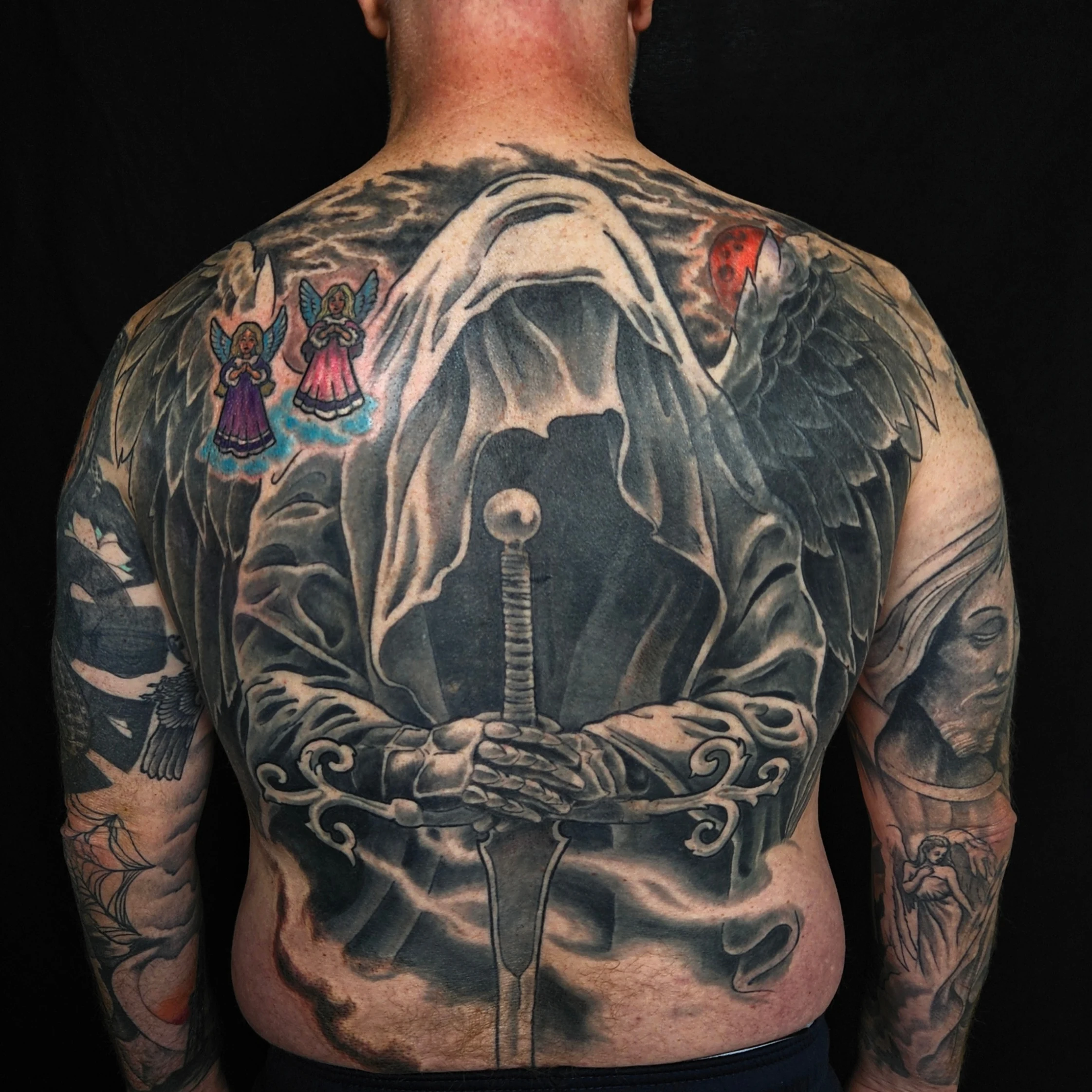 Large black and grey grim reaper back tattoo