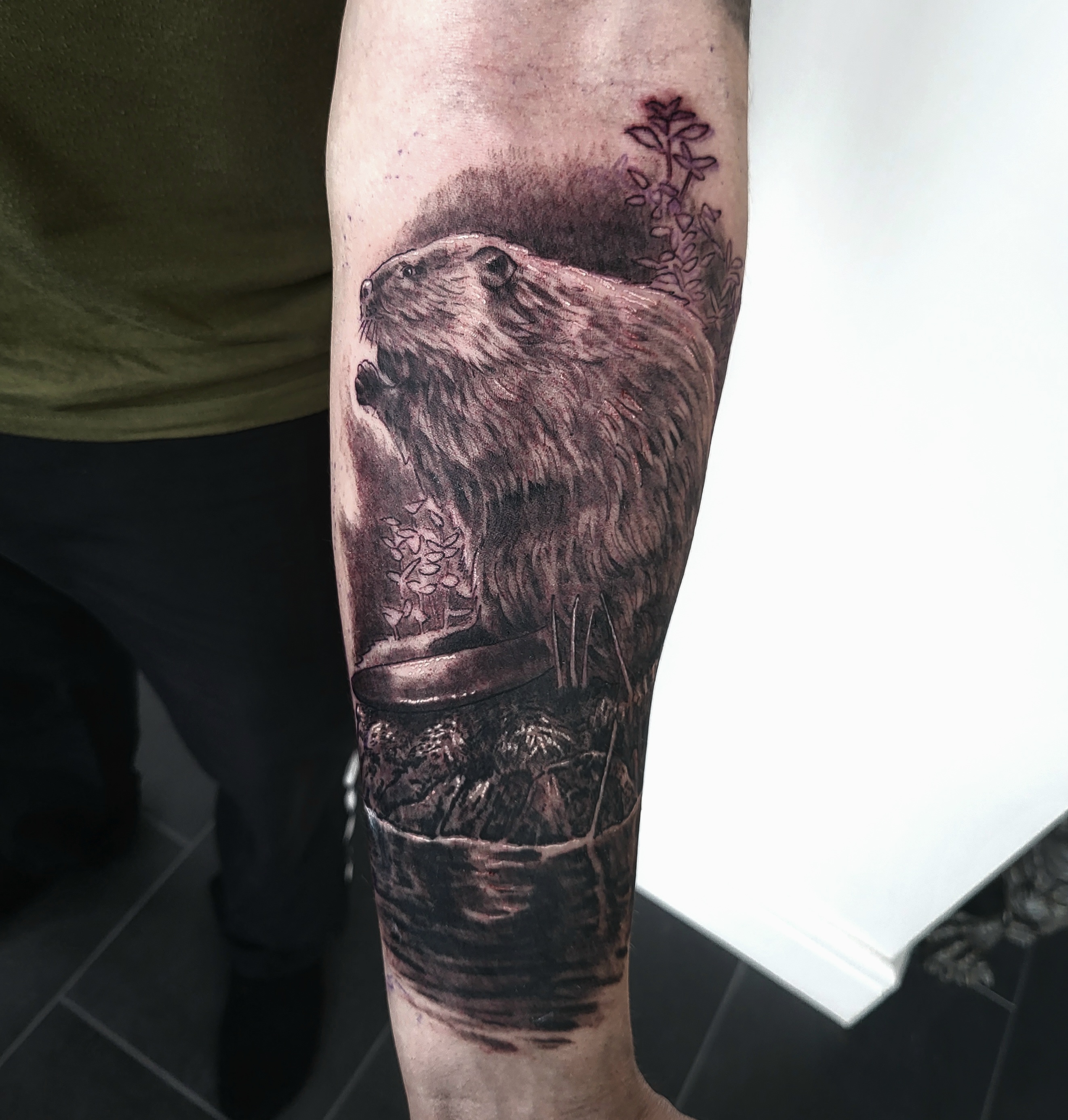 Realistic otter forearm tattoo