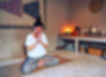 Woman meditates peacefully in yoga studio