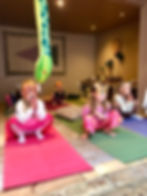 Children in animal masks practice yoga
