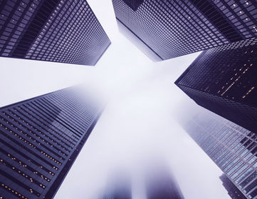 Low-angle view of skyscrapers in fog