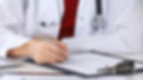 Doctor writing on paper.